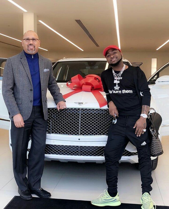 Davido posing with his Bentley Bentyga