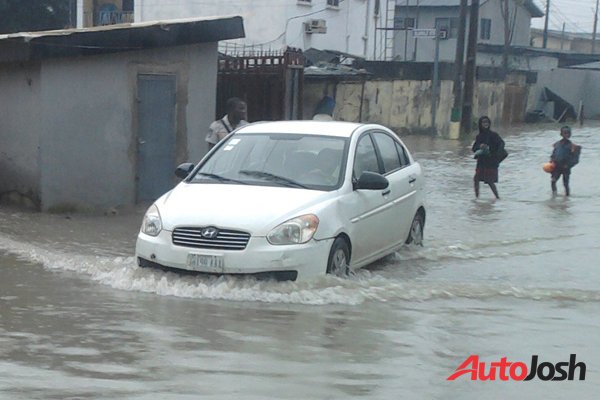 car driving through flooded road