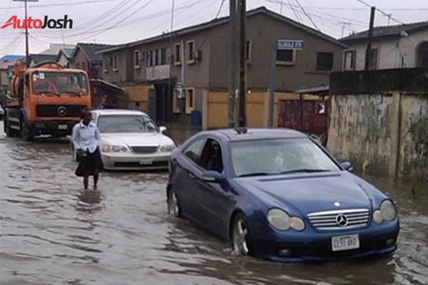 cars driving through a flooded road