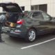 man loading his car trunk