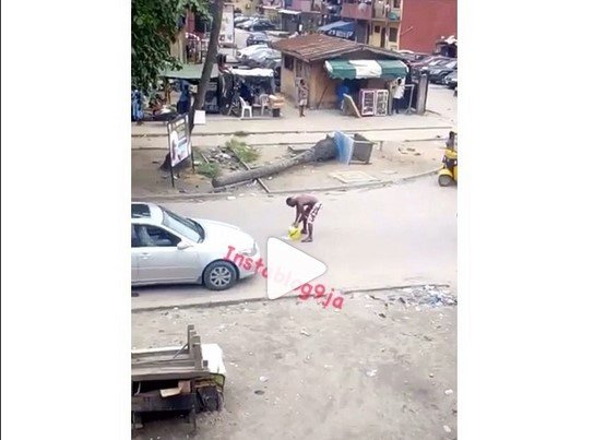 man washing on road