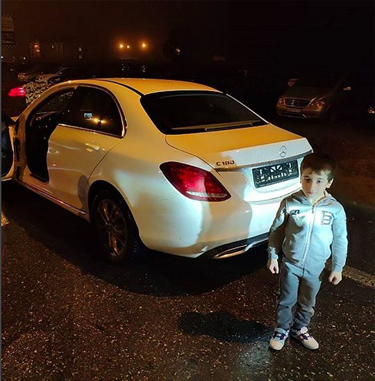 5-year-old boy poses with the mercedes Benz gifted him