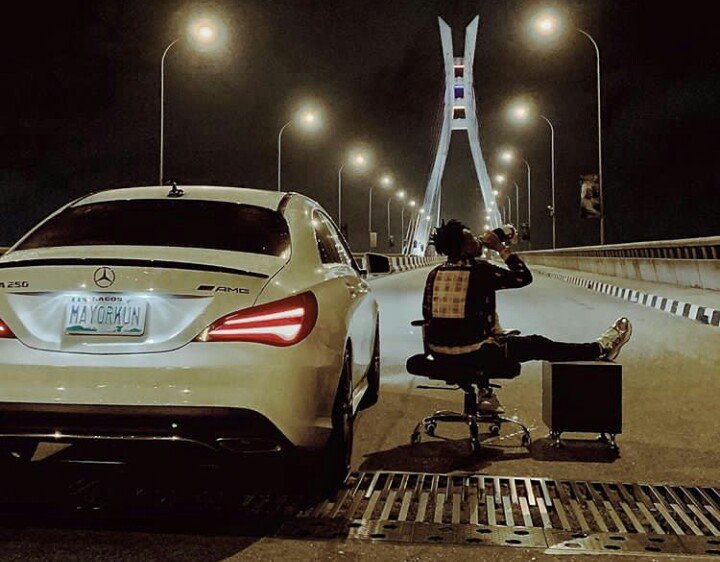 mayorkun sitting with his Benz CLA250 on Lekki-Ikoyi link bridge 