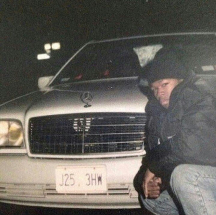 19-year-old 50 cent posing with his benz