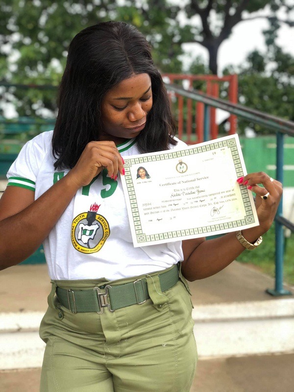 female corper posing with her SUV 