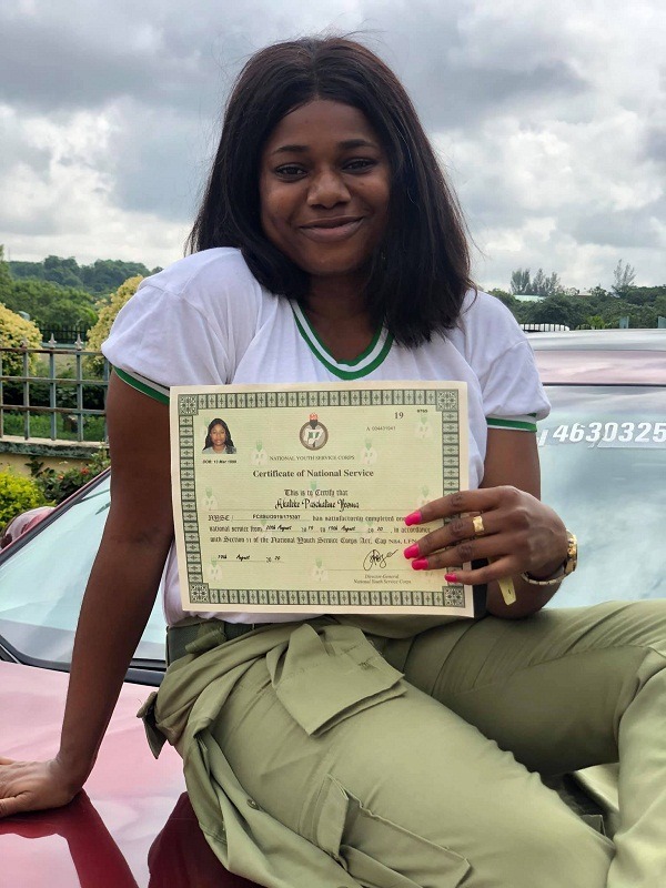 female corper posing with her SUV 