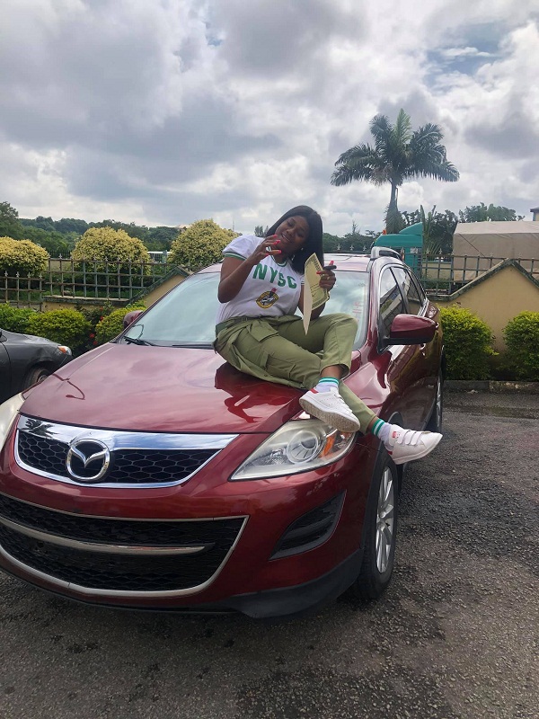 female corper posing with her SUV 