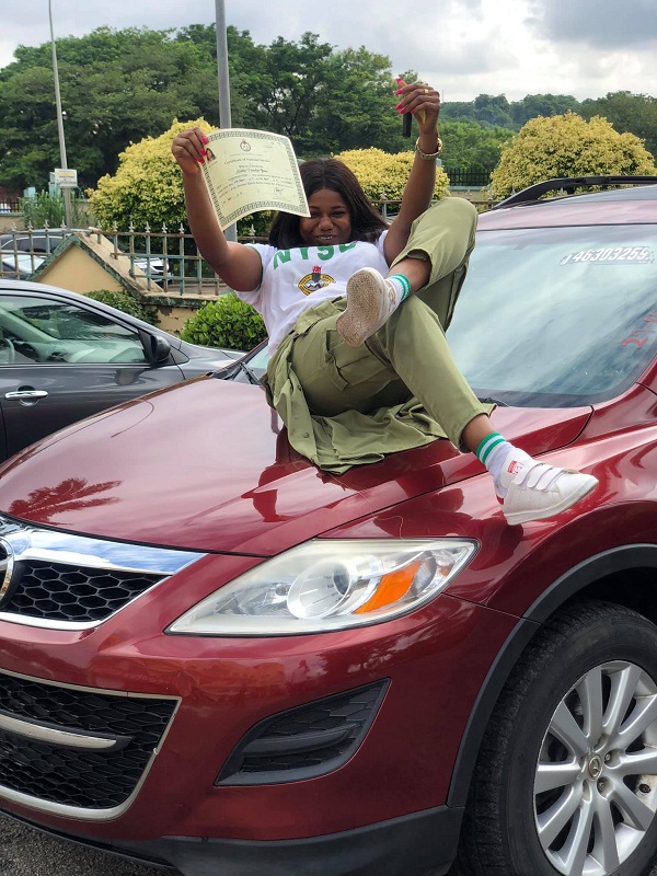 female corper posing with her SUV 