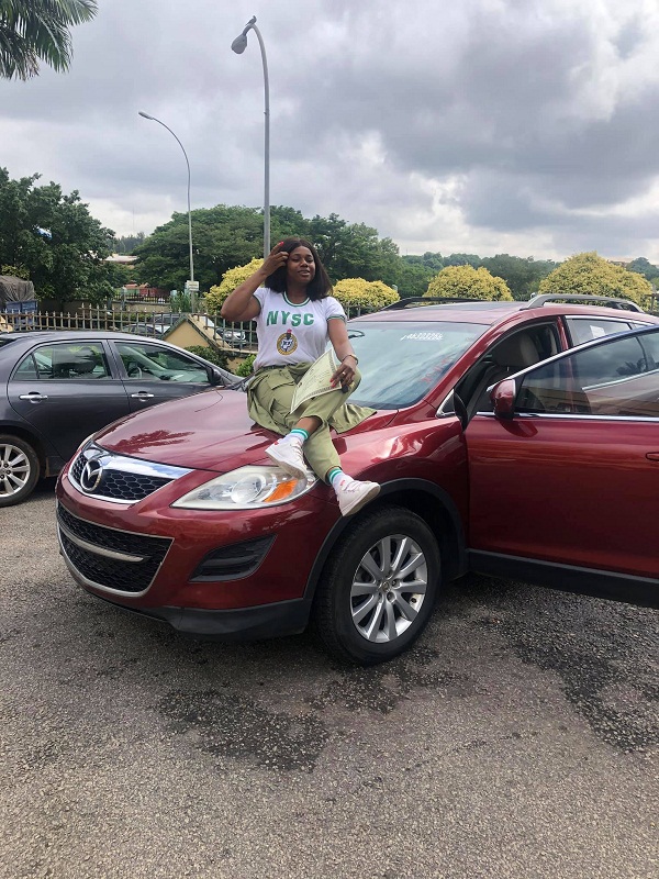 female corper posing with her SUV 