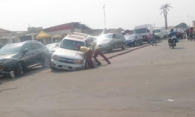 Today's Photo : LASTMA Officers Helping A Motorist To Pull Out The Front Tyre Of His SUV Stuck In A Ditch - autojosh