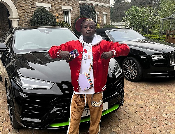 Portable In London : Singer Gets  Cash Gift From Pastor Tobi, Poses  With His Rolls-Royce, Lamborghini, Maserati