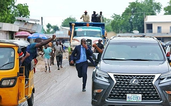 Today's Photo : Gov. Zulum Of Borno State Shakes Hands With A Kid As His Convoy Rides Through The City - autojosh 