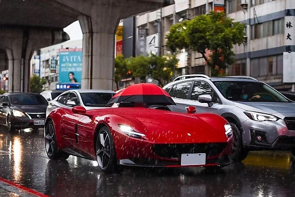 Owner Of Roofless Ferrari Monza SP1 Worth N5 Billion Forced To Use Umbrella During Heavy Rain - autojosh 