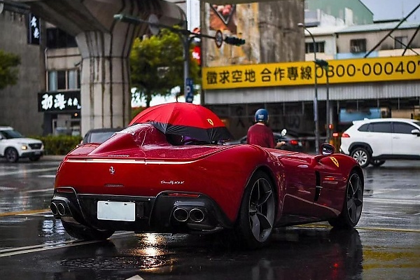 Owner Of Roofless Ferrari Monza SP1 Worth N5 Billion Forced To Use Umbrella During Heavy Rain - autojosh 