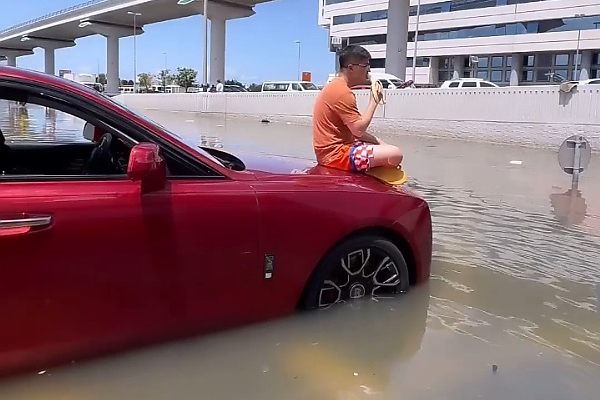 Stranded Man Sits On The Bonnet Of His Rolls-Royce Ghost Worth N800m Caught In Dubai Flood - autojosh 