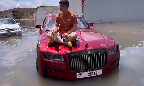 Stranded Man Sits On The Bonnet Of His Rolls-Royce Ghost Worth N800m Caught In Dubai Flood - autojosh